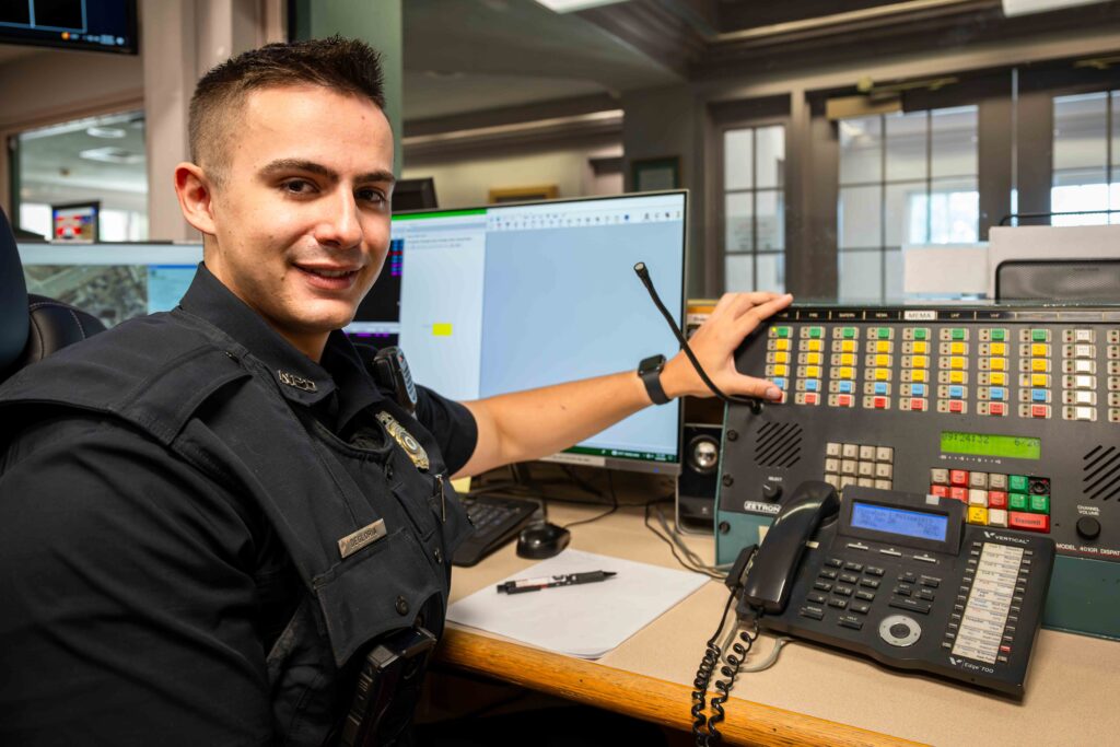 A male police officer at a desk.